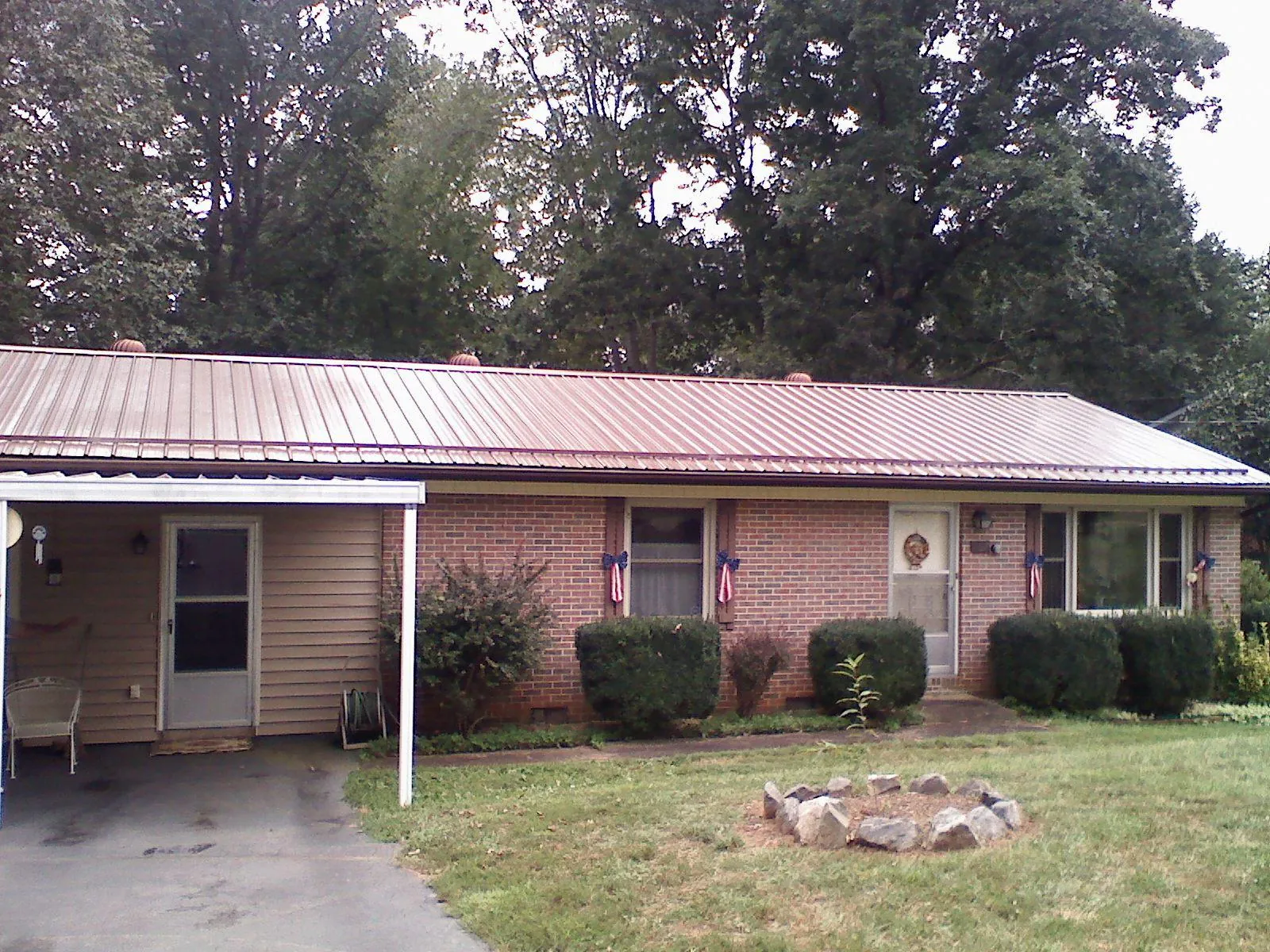 Bronze metal roof and carport on a brick ranch home — Roof Repair work by our crew in Big Bear Lake