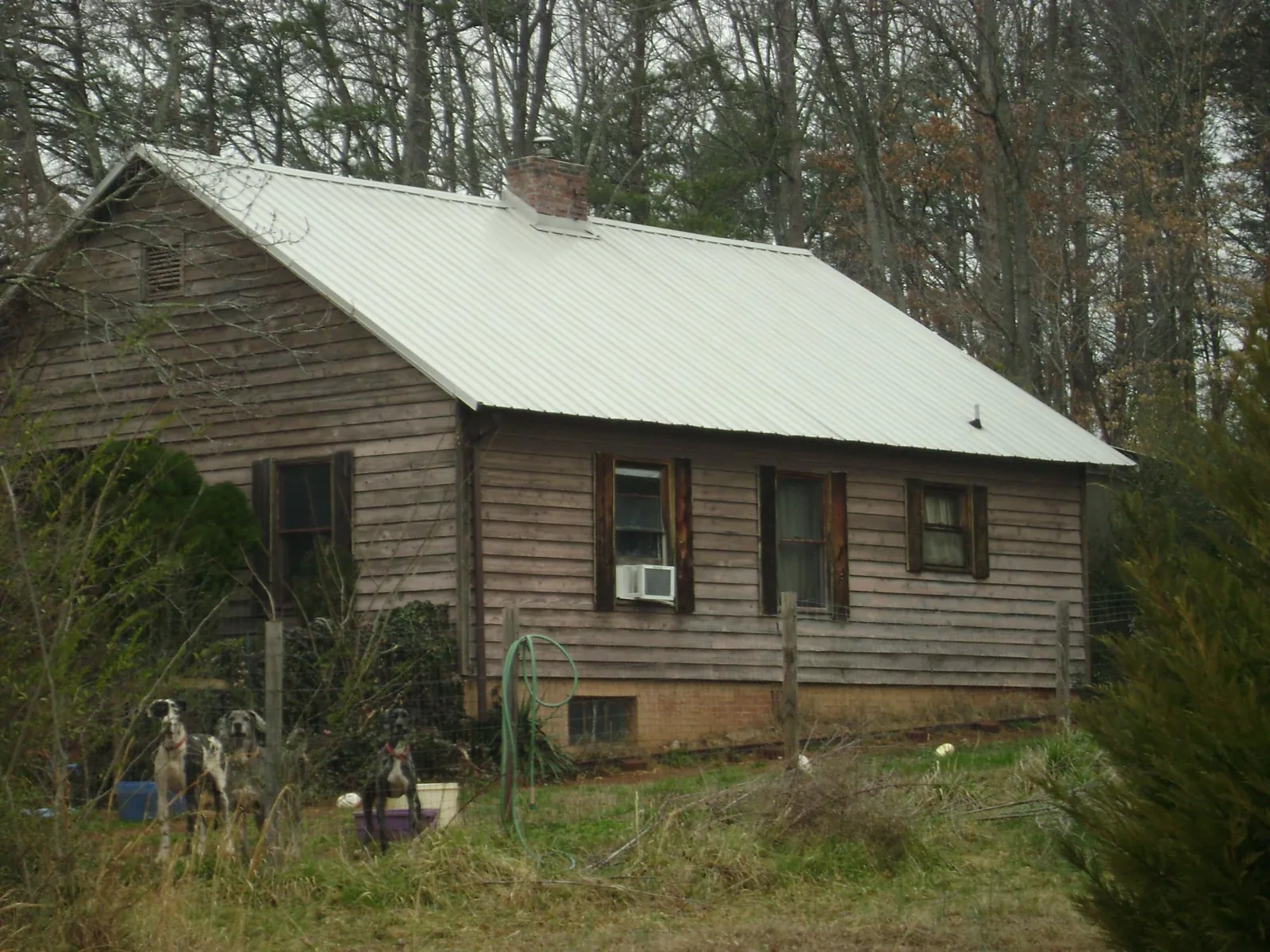 White metal roof on an old wood sided farmhouse, from a Metal Roof Installation job in Big Bear Lake